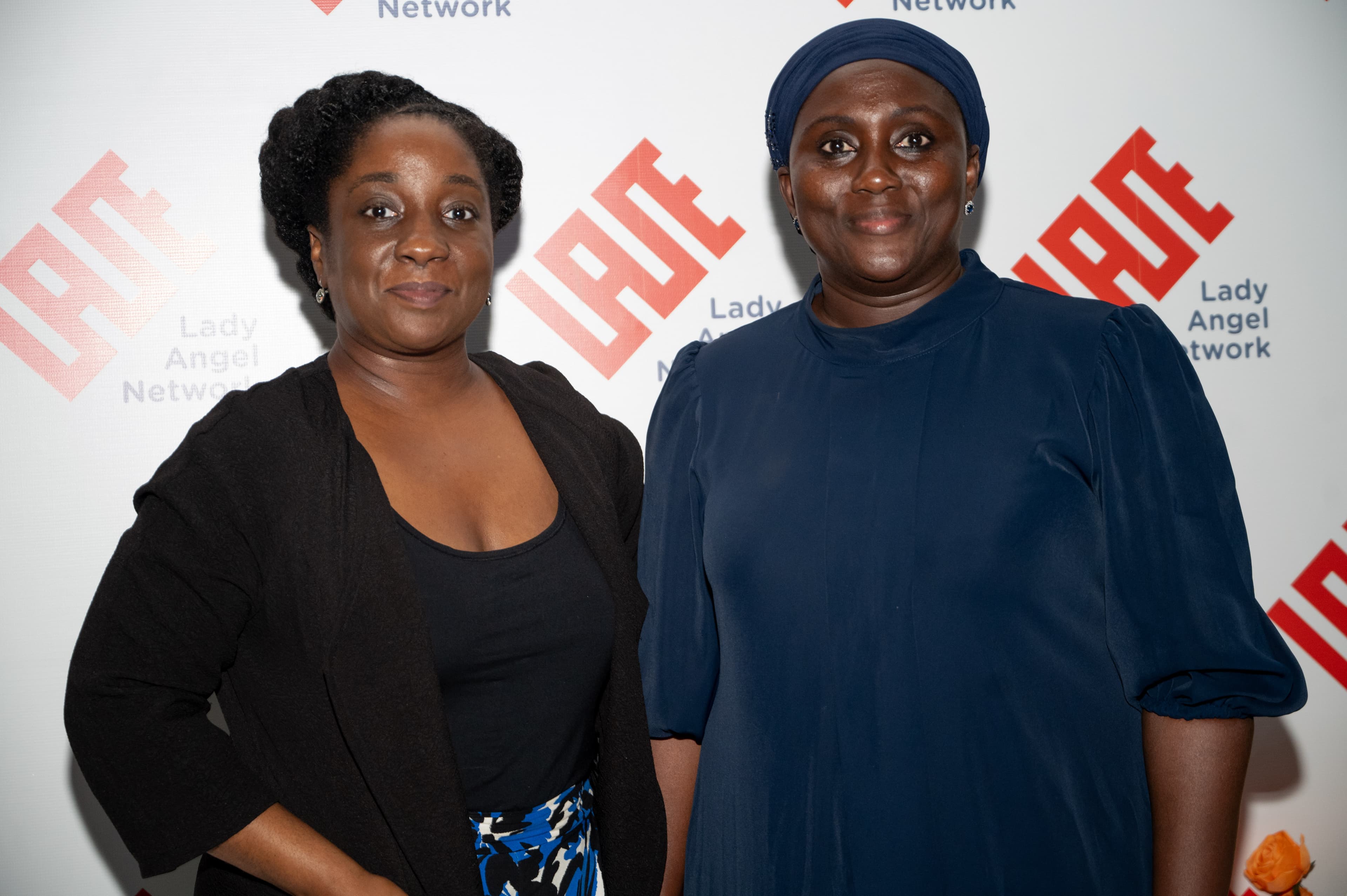 Two Lady Angel Network members photographed together at a branded event.